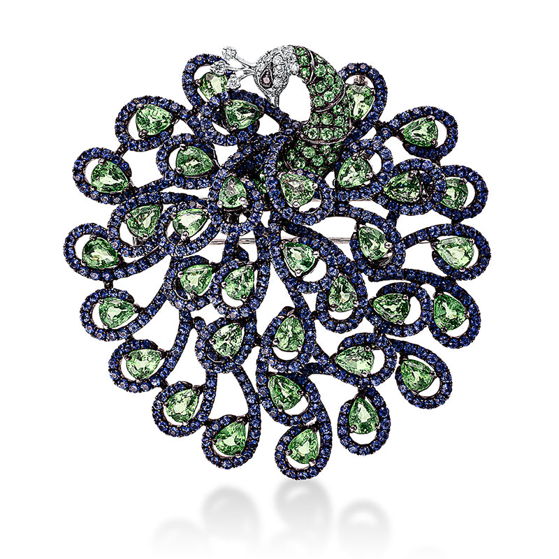 Brosche 18 kt WG Pfau. Fassung schwarz rhodiniert. 23 Brillanten 0.15 ct. TW-vsi/si. 34 Tsavorith 9.43 ct blau. 606 Saphire 6.85 ct multicolor
