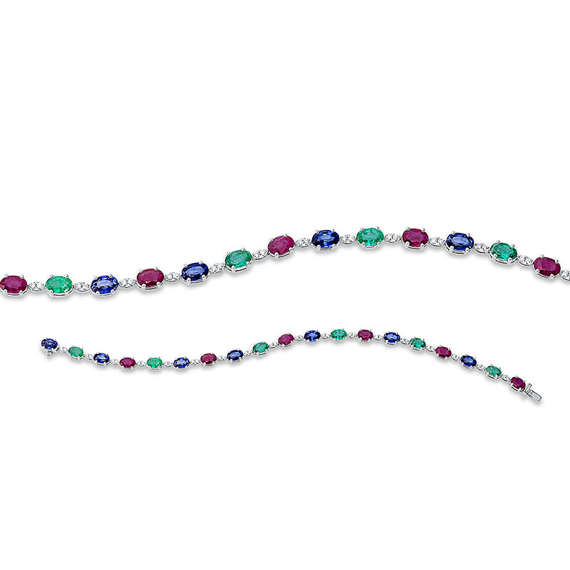 Armband 18 kt WG. 36 Brillanten 0.31 ct. TW-si. 7 Smaragde 2.33 ct grün. 6 Saphire 3.94 ct blau. 6 Rubine 2.90 ct rot. B:4.4 mm