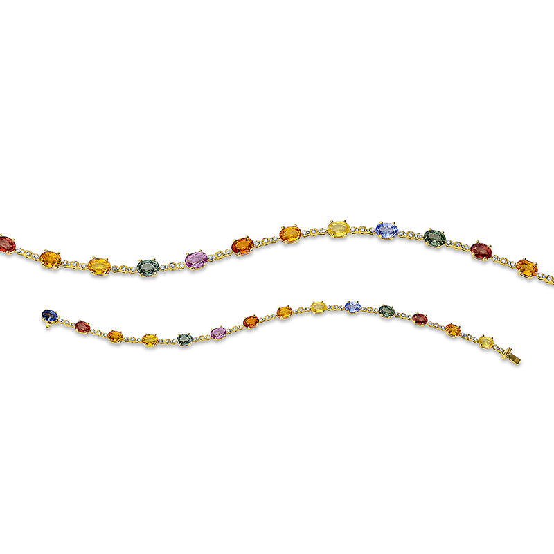 Armband 18 kt GG. 41 Brillanten 0.30 ct. TW-si. 27 Brillanten 0.06 ct. TW-si. 14 Saphire 8.96 ct multicolor. B:4.7 mm. L:18.0 cm