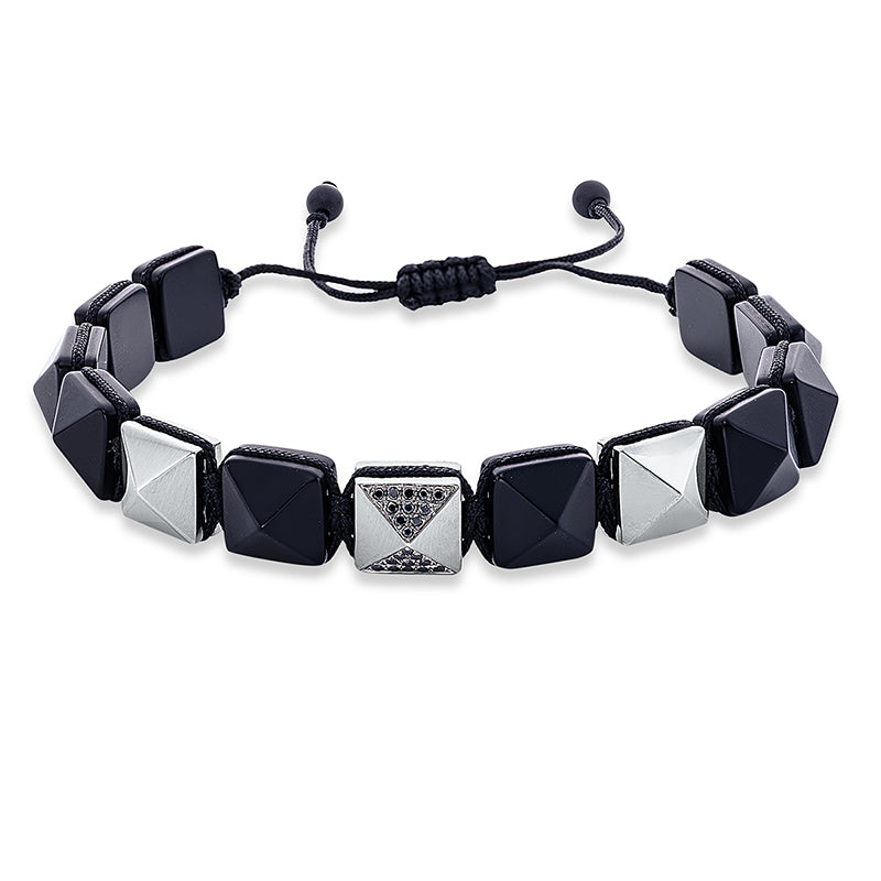 Armband 18 kt WG. black cord strap. 20 Brillanten 0.13 ct. schwarz. 2 Brillanten 0.01 ct. schwarz. 12 Onyx 57.95 ct schwarz. B:10.0 mm. L:31.0 cm. S:6.2 mm