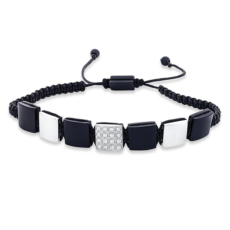 Armband 18 kt WG. black cord strap. 16 Brillanten 0.21 ct. TW-si. 7 Onyx 18.61 ct schwarz. B:10.0 mm. L:31.0 cm. S:3.7 mm