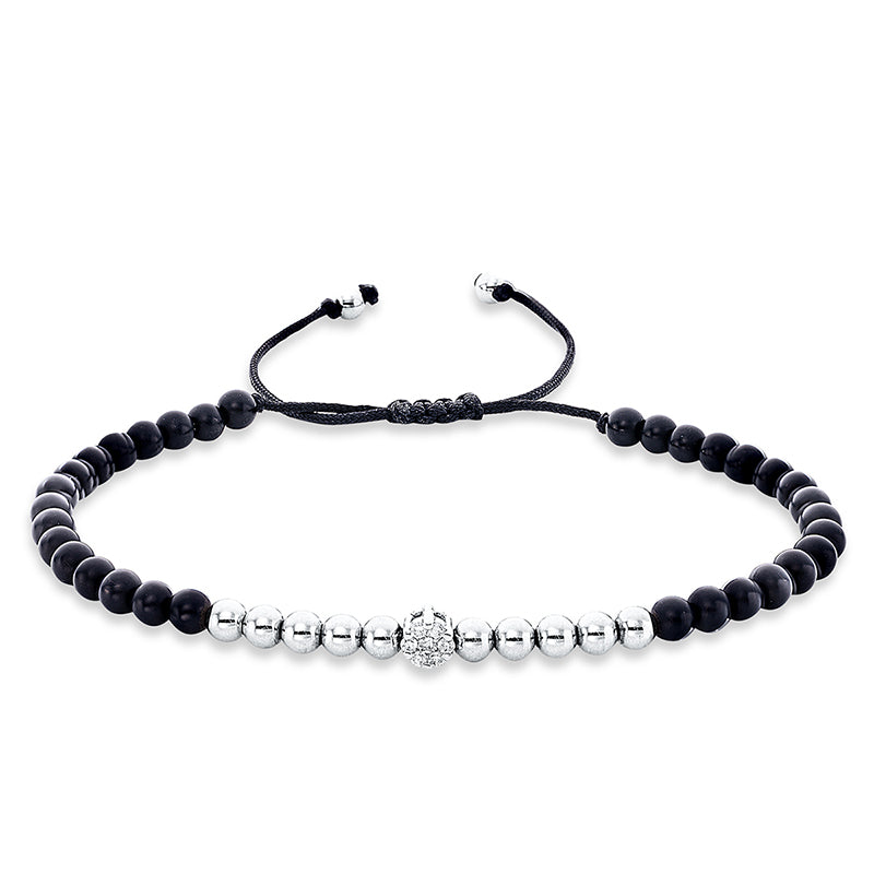 Armband 18 kt WG. black cord strap.gold ball. 1 Brill. 0.04 ct. TW-si. 6 Brillanten 0.11 ct. TW-si. 32 Onyx 14.66 ct schwarz. B:5.0 mm. L:31.0 cm. S:4.1 mm